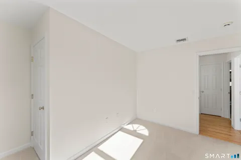 a bathroom with a granite countertop sink a toilet and a mirror