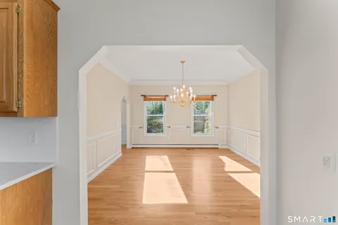 a view of a room with a window and chandelier