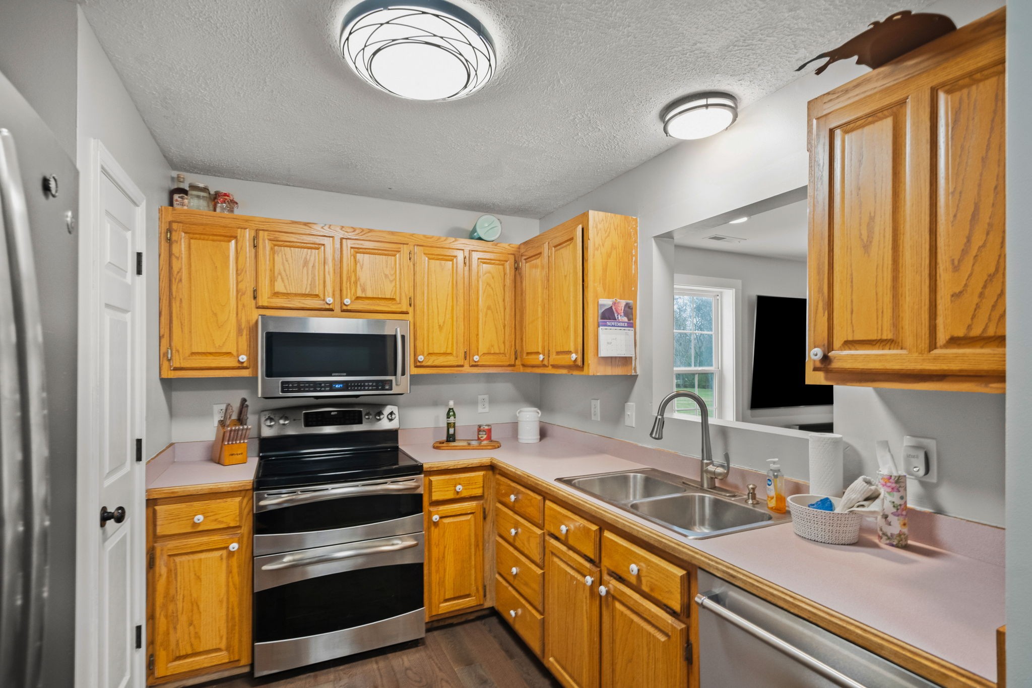 6117 Henry Gower Road Pleasant View, TN 37146 - Photo 12 of 61 a kitchen with stainless steel appliances a stove sink and microwave