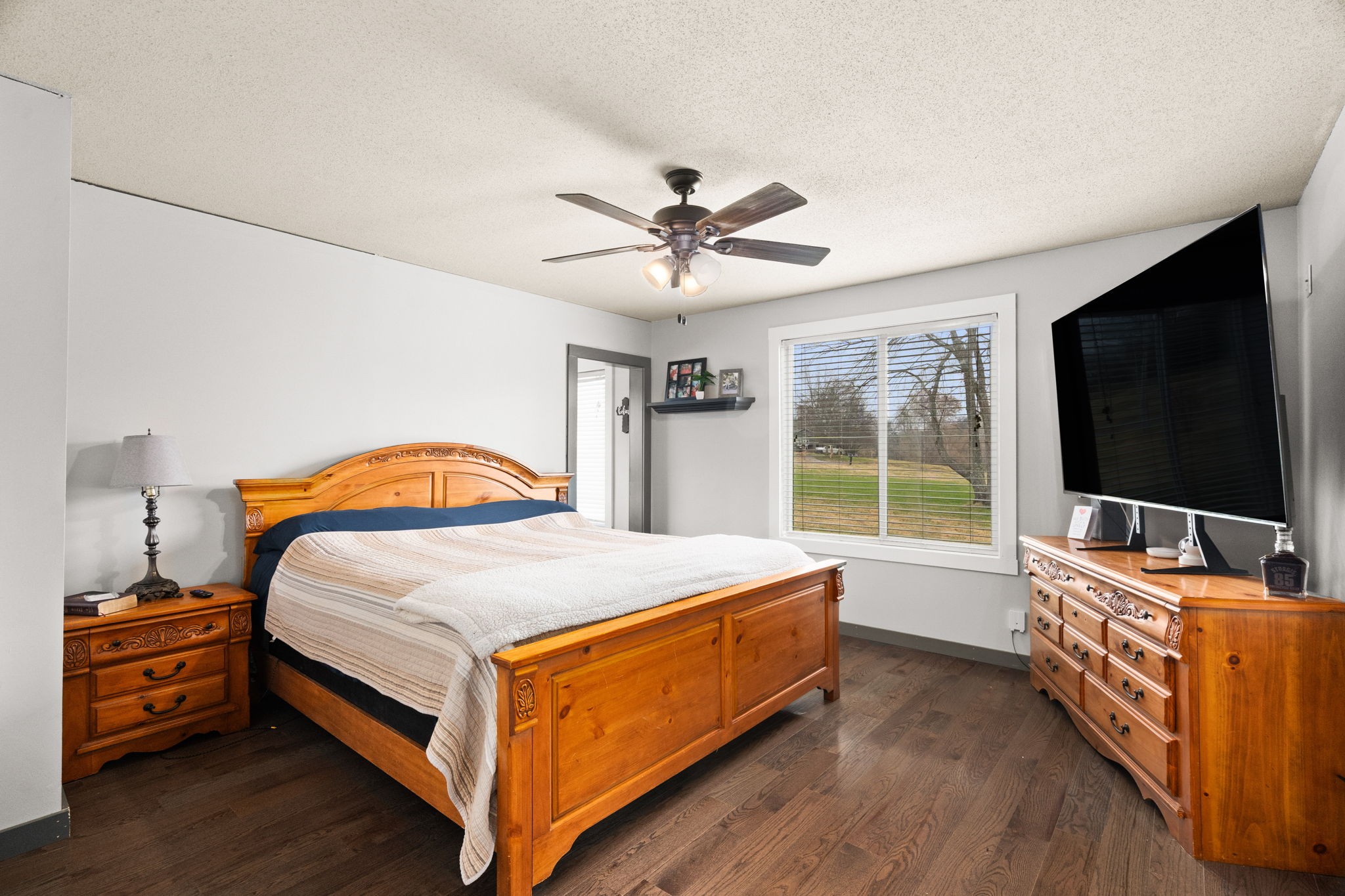 6117 Henry Gower Road Pleasant View, TN 37146 - Photo 18 of 61 a bedroom with bed and a flat tv screen on dresser