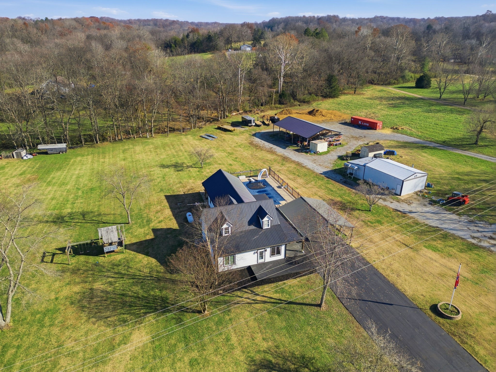 6117 Henry Gower Road Pleasant View, TN 37146 - Photo 50 of 61 a view of a lake with lawn chairs and large trees