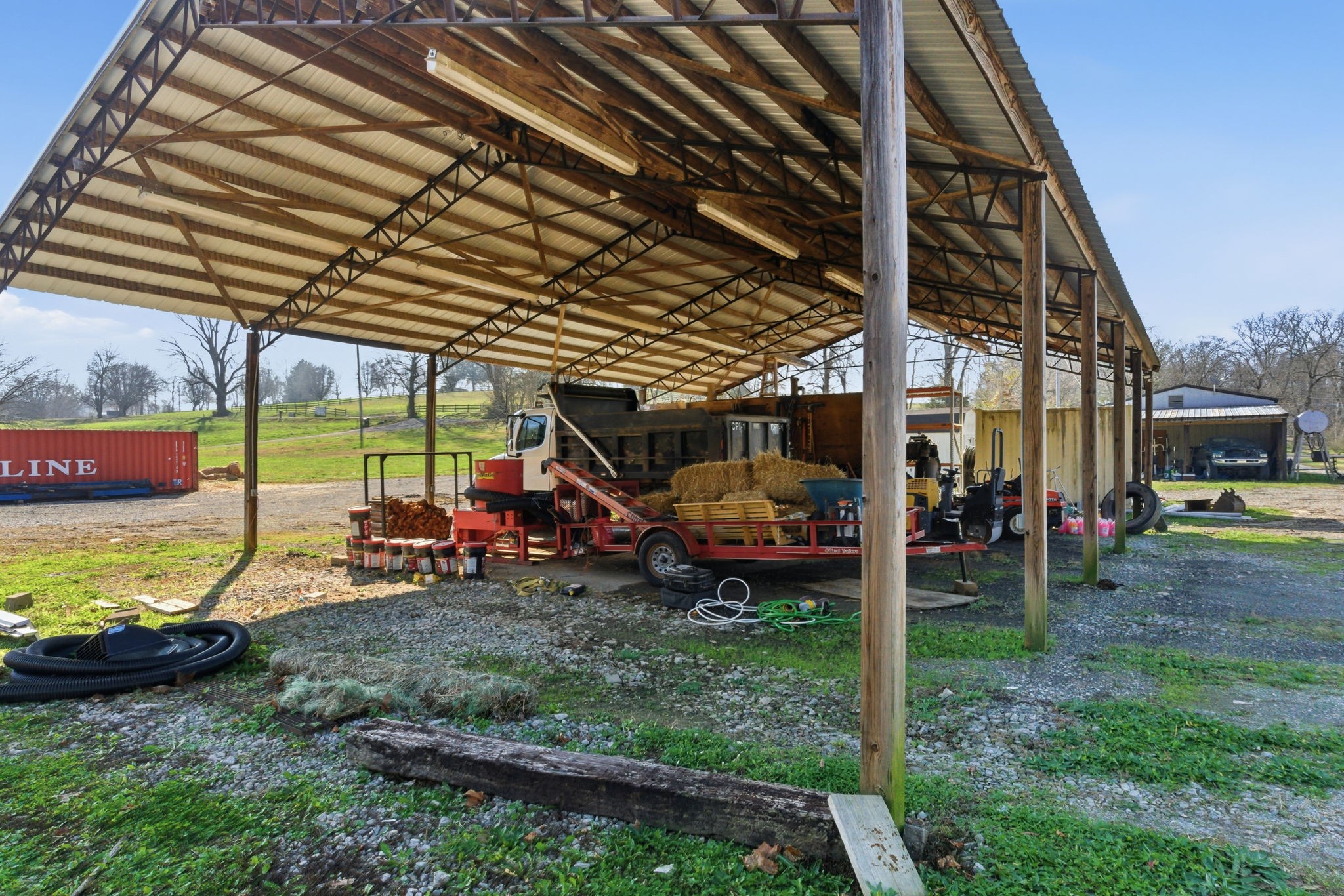 6117 Henry Gower Road Pleasant View, TN 37146 - Photo 59 of 61 a view of a yard with table and chairs under an umbrella