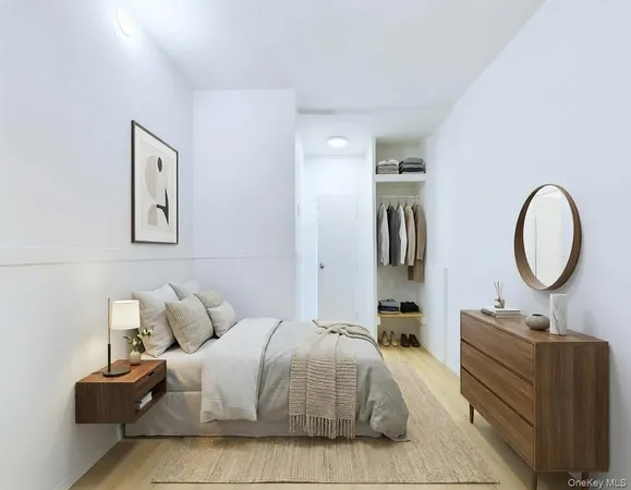 a bedroom with bed and a large mirror