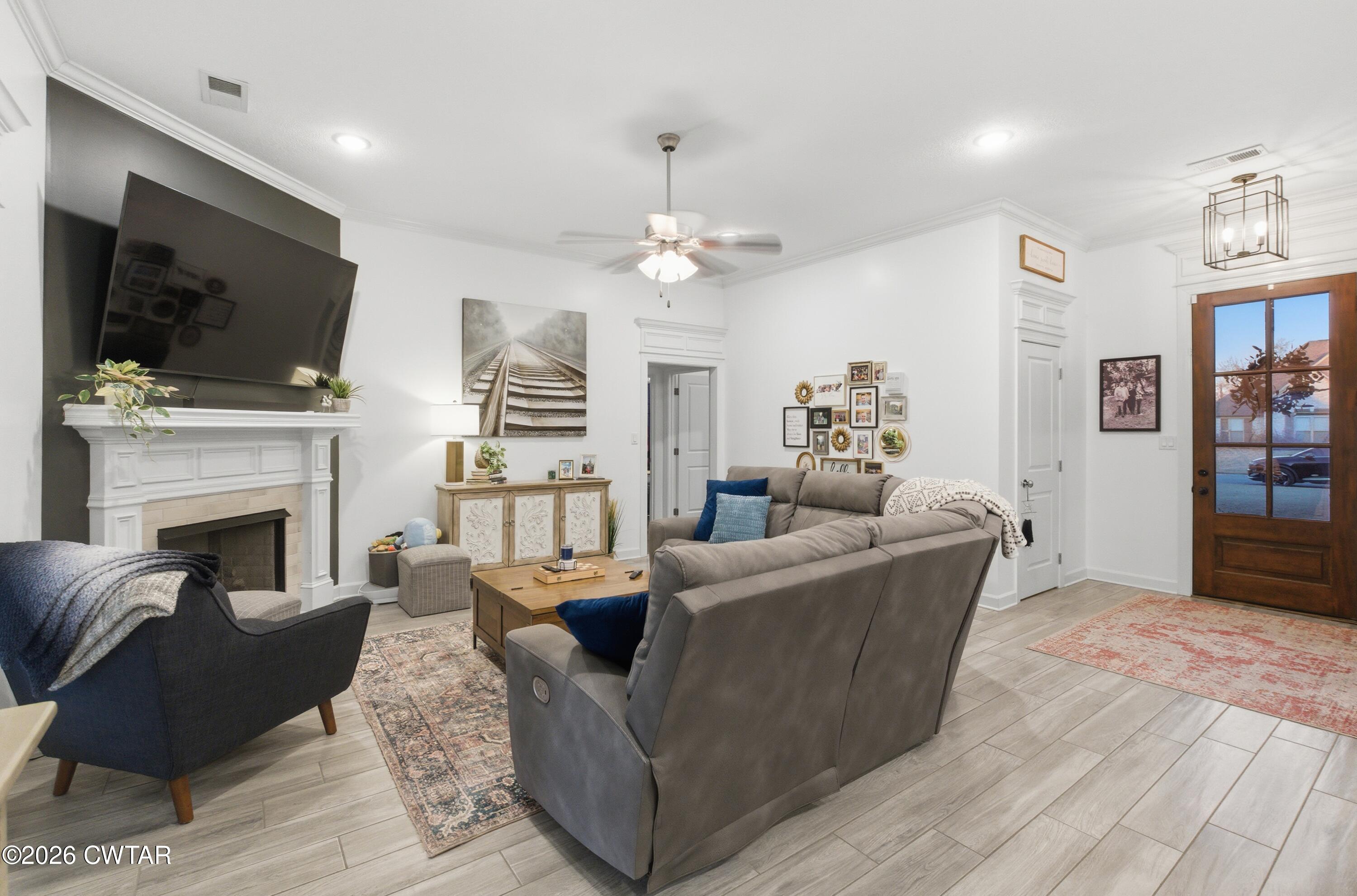 5 Pinehill Cove Jackson, TN 38305 - Photo 13 of 47 a living room with furniture a flat screen tv and a fireplace