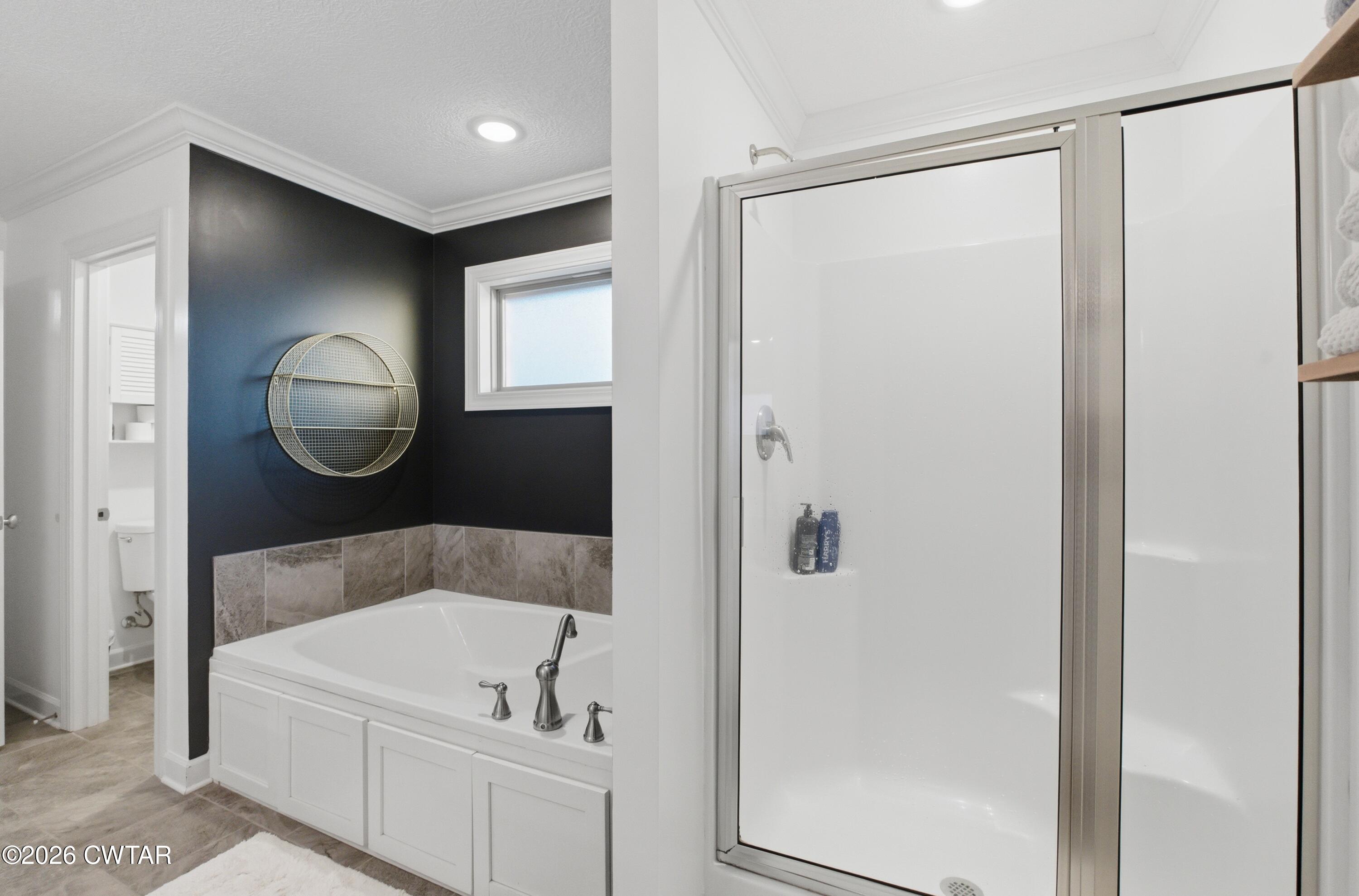5 Pinehill Cove Jackson, TN 38305 - Photo 19 of 47 a bathroom with a tub shower and mirror