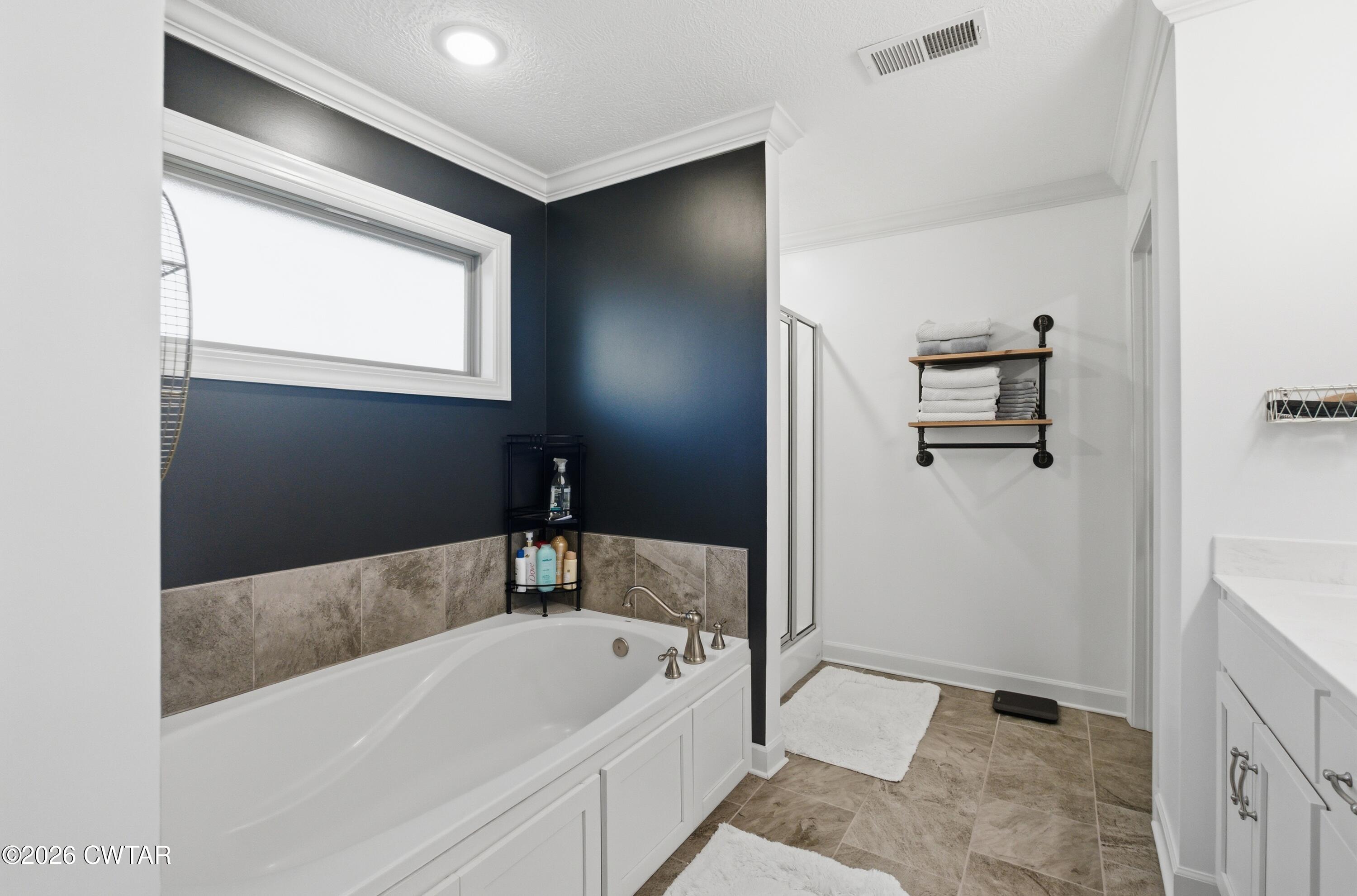 5 Pinehill Cove Jackson, TN 38305 - Photo 20 of 47 a bathroom with a tub and a shower