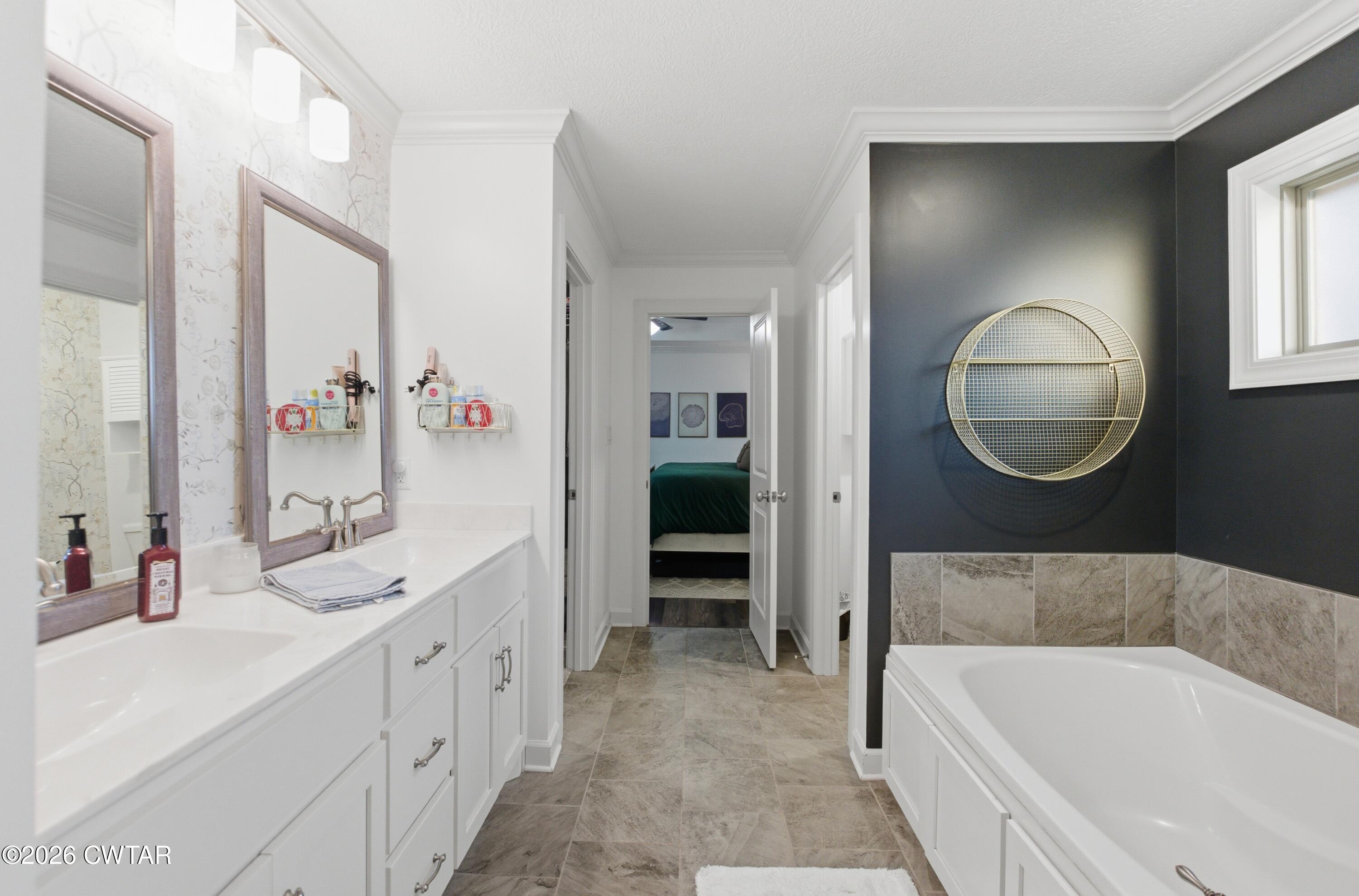 5 Pinehill Cove Jackson, TN 38305 - Photo 21 of 47 a bathroom with a tub sink and mirror