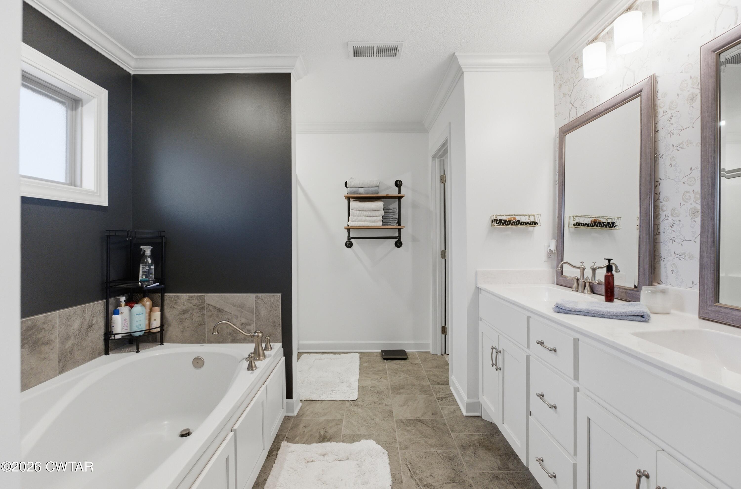 5 Pinehill Cove Jackson, TN 38305 - Photo 22 of 47 a bathroom with a tub a sink and a large mirror