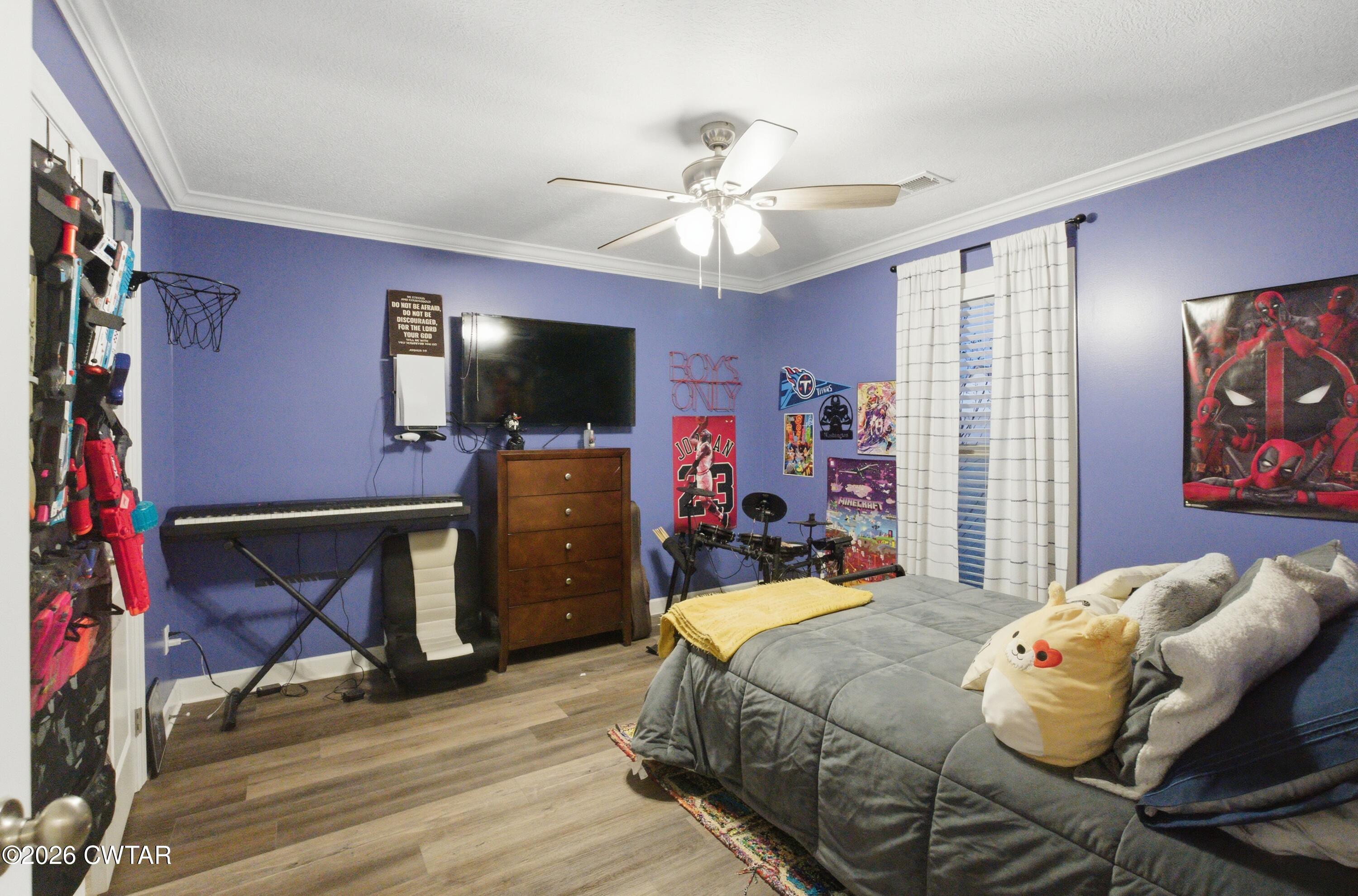 5 Pinehill Cove Jackson, TN 38305 - Photo 25 of 47 a bedroom with a bed and a flat screen tv