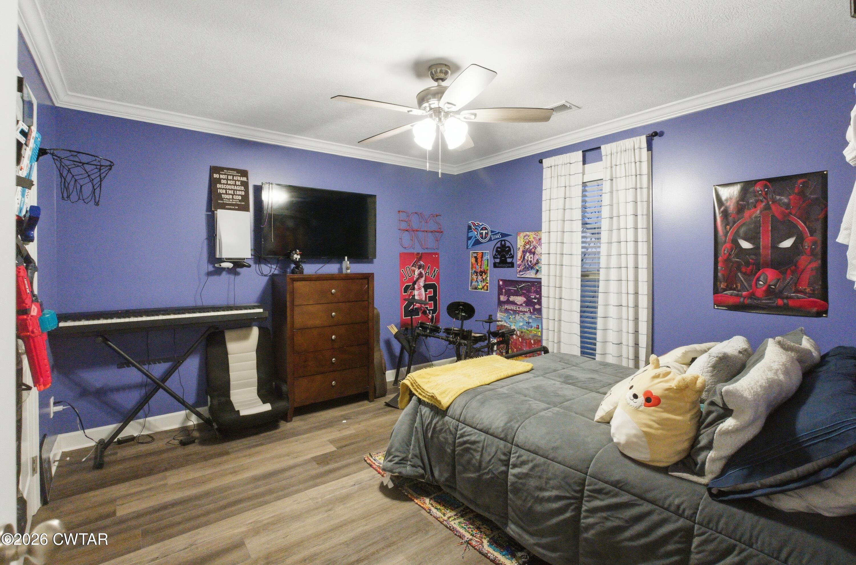 5 Pinehill Cove Jackson, TN 38305 - Photo 26 of 47 a bedroom with a bed and flat screen tv