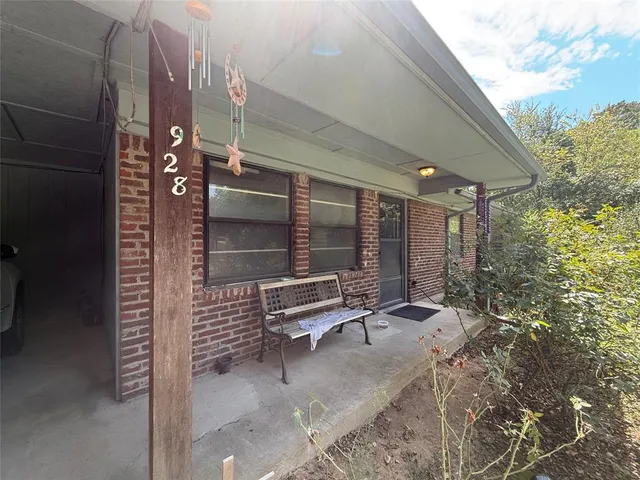 a building outdoor space with patio furniture and potted plants