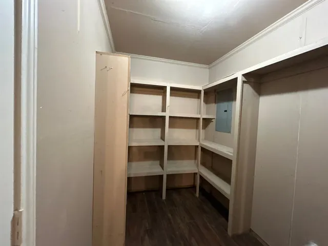 a view of walk in closet with empty racks