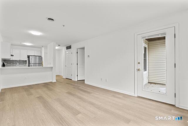 468 Main Street, Unit 111 East Lyme, CT 06357 - Photo 16 of 25 a view of an empty room with a kitchen