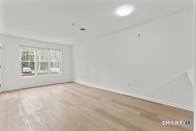 468 Main Street, Unit 111 East Lyme, CT 06357 - Photo 18 of 25 an empty room with windows