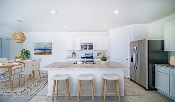 a kitchen with kitchen island cabinets and refrigerator