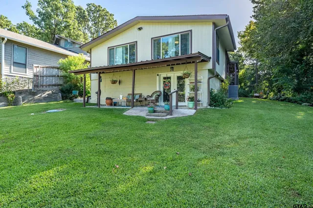 a view of a house with a yard and sitting area