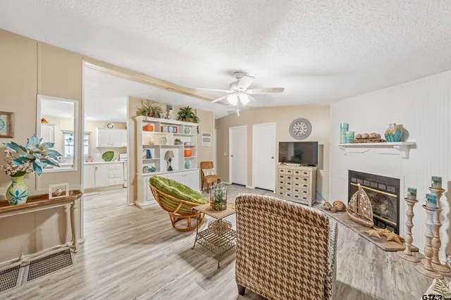 a living room with furniture a fireplace and a flat screen tv