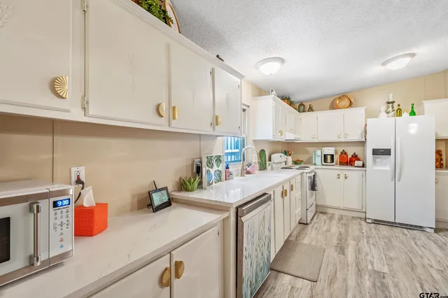 a kitchen with cabinets and refrigerator