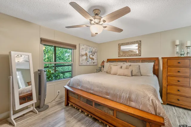 a bedroom with a bed and a large window