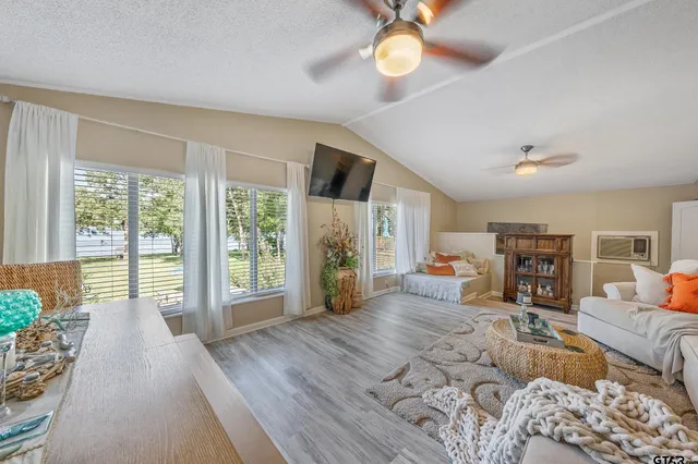 a living room with furniture large window and flat screen tv