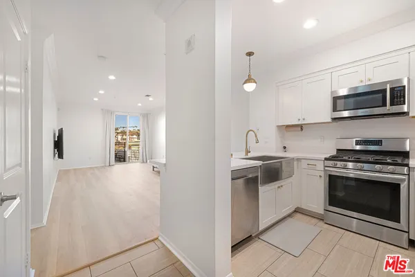 a kitchen with stainless steel appliances granite countertop a stove and a sink