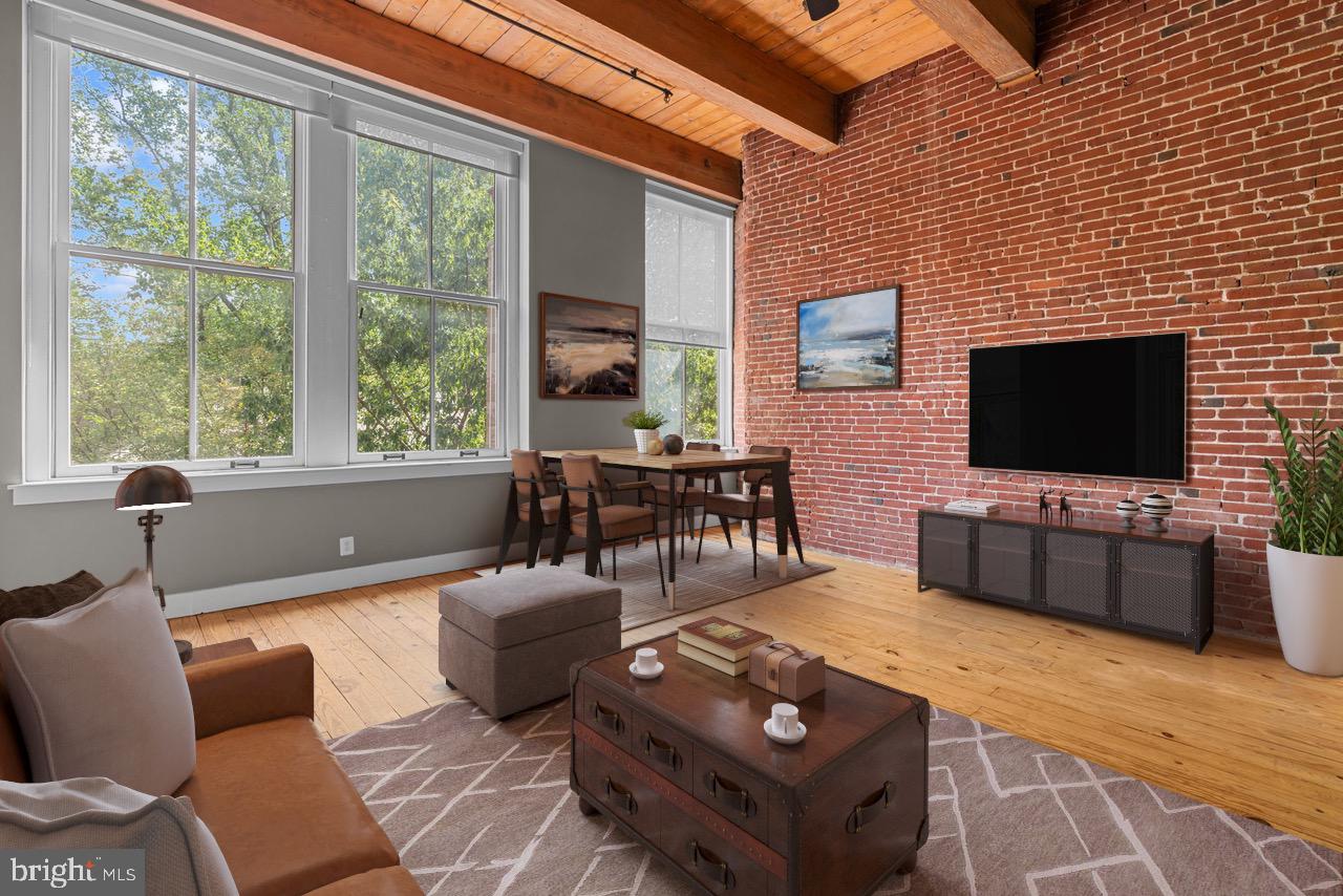 a living room with furniture a flat screen tv and a floor to ceiling window