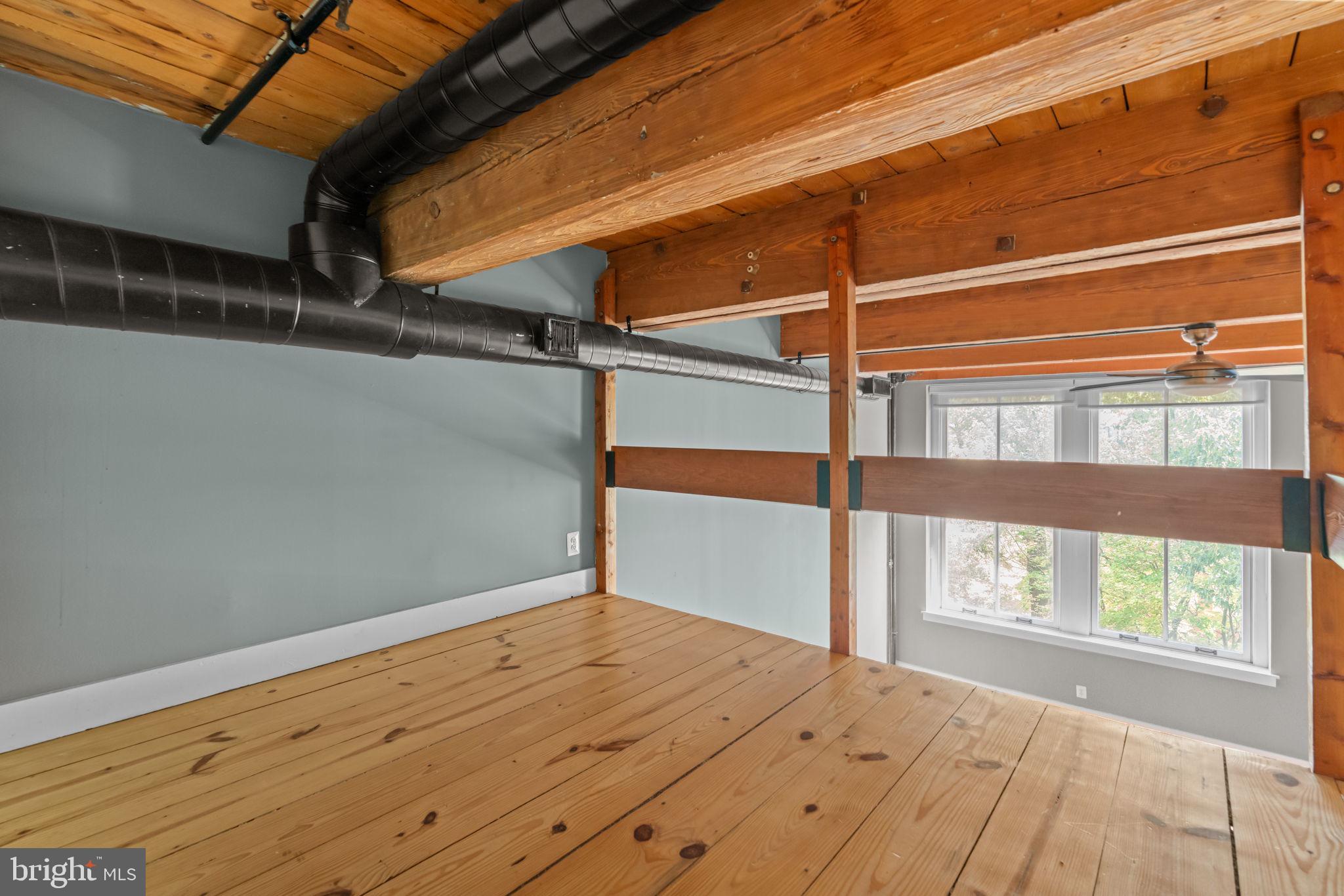 309 Arch Street, Unit 301 Philadelphia, PA 19106 - Photo 11 of 36 a view of a room with wooden floor and windows