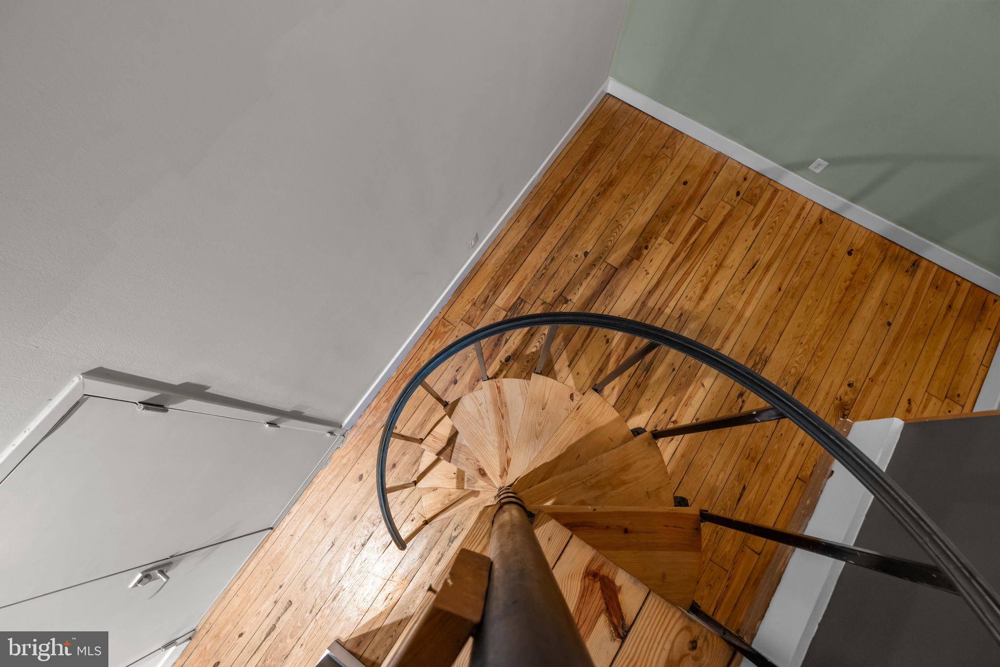 309 Arch Street, Unit 301 Philadelphia, PA 19106 - Photo 15 of 36 a view of staircase with railing and a painting on the wall