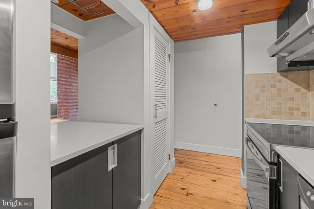 a view of a balcony with wooden floor and a window