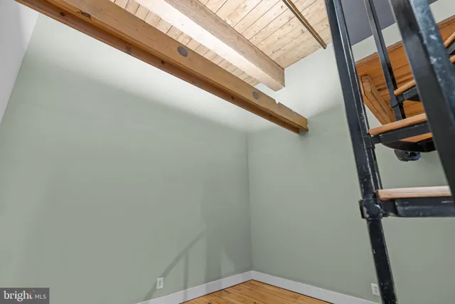 a view of a room with wooden floor and stairs