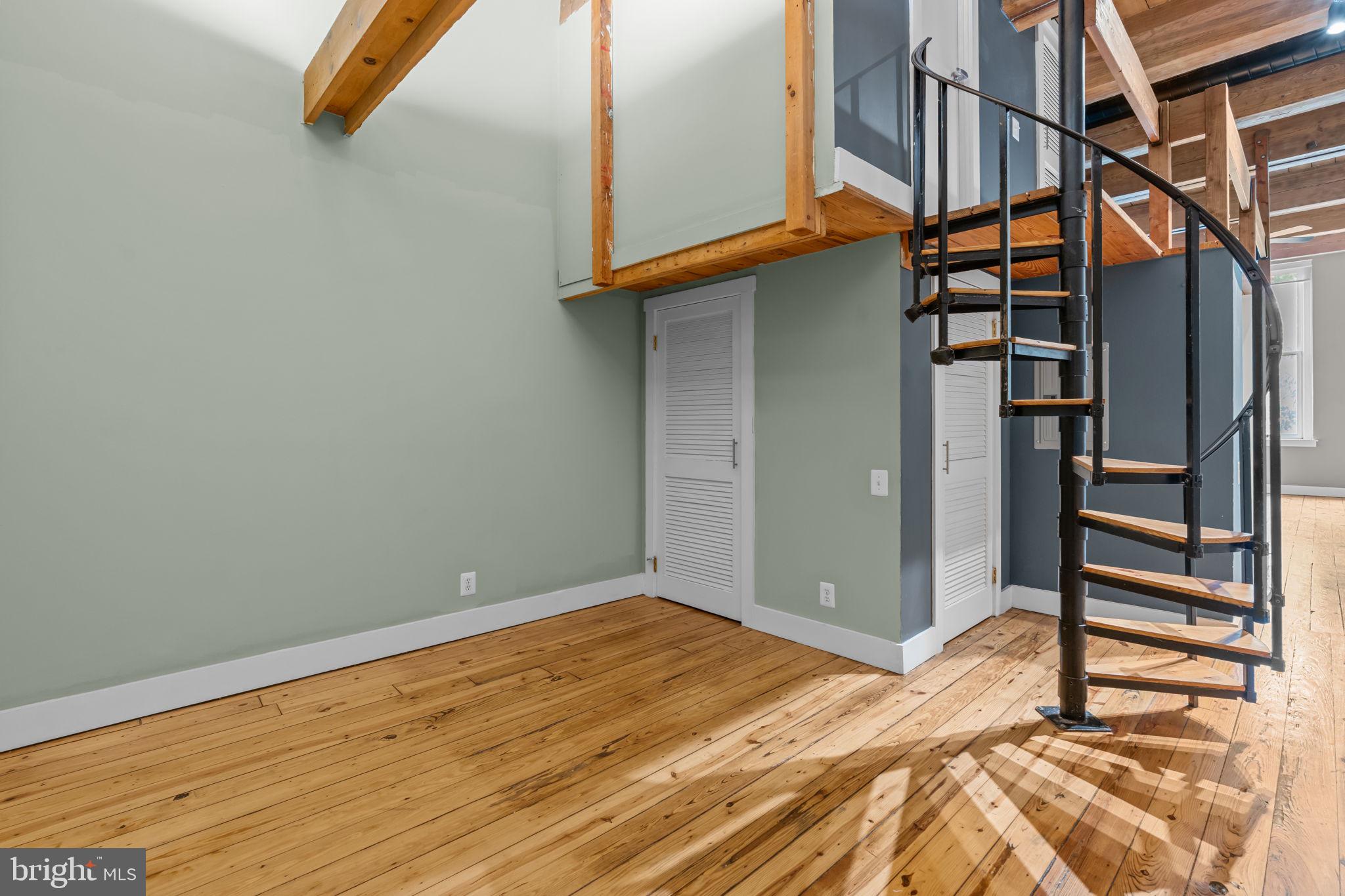 309 Arch Street, Unit 301 Philadelphia, PA 19106 - Photo 28 of 36 a view of a room with wooden floor and stairs