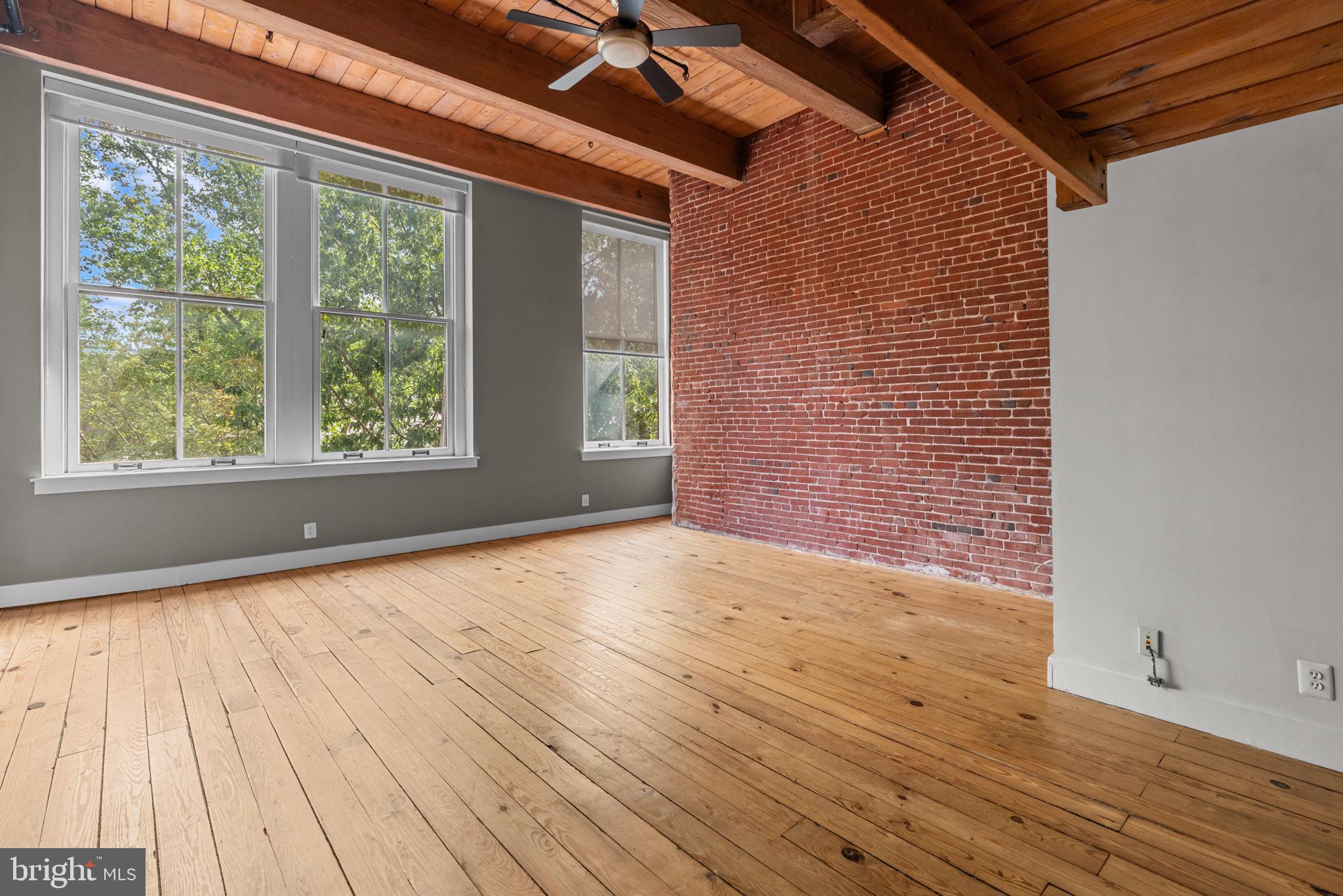 309 Arch Street, Unit 301 Philadelphia, PA 19106 - Photo 3 of 36 a view of an empty room with wooden floor and a window