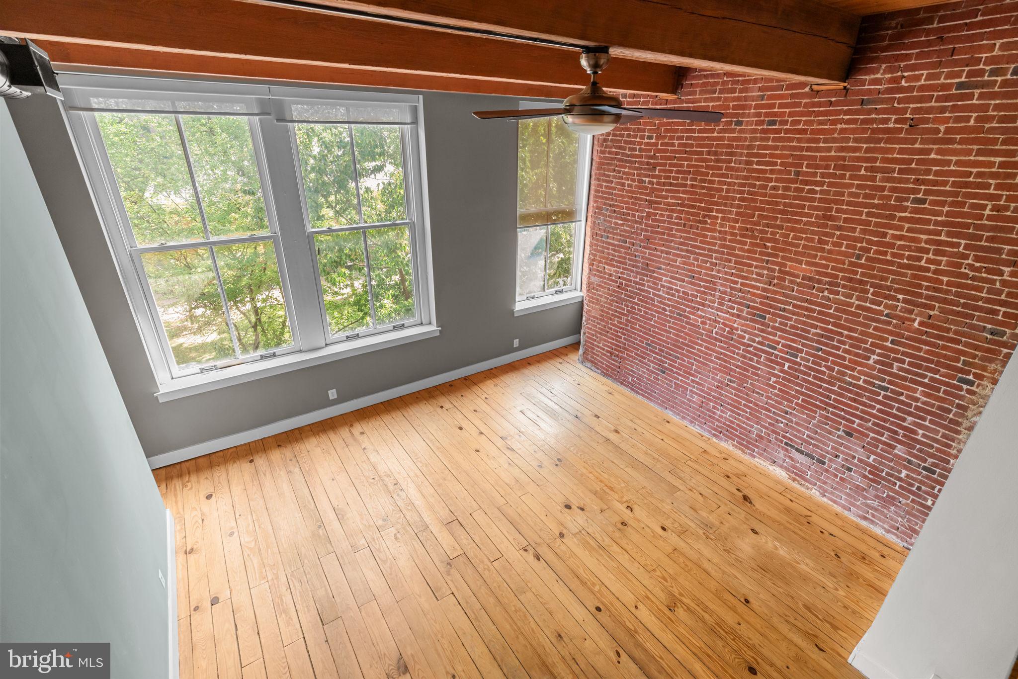 309 Arch Street, Unit 301 Philadelphia, PA 19106 - Photo 9 of 36 a view of an empty room with wooden floor and a window