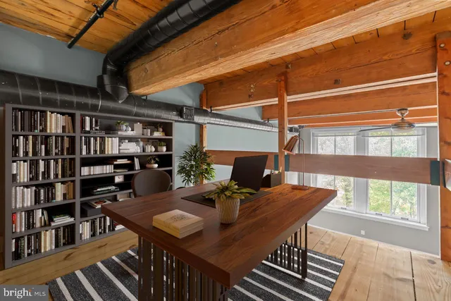 a view of a room with wooden floor and windows