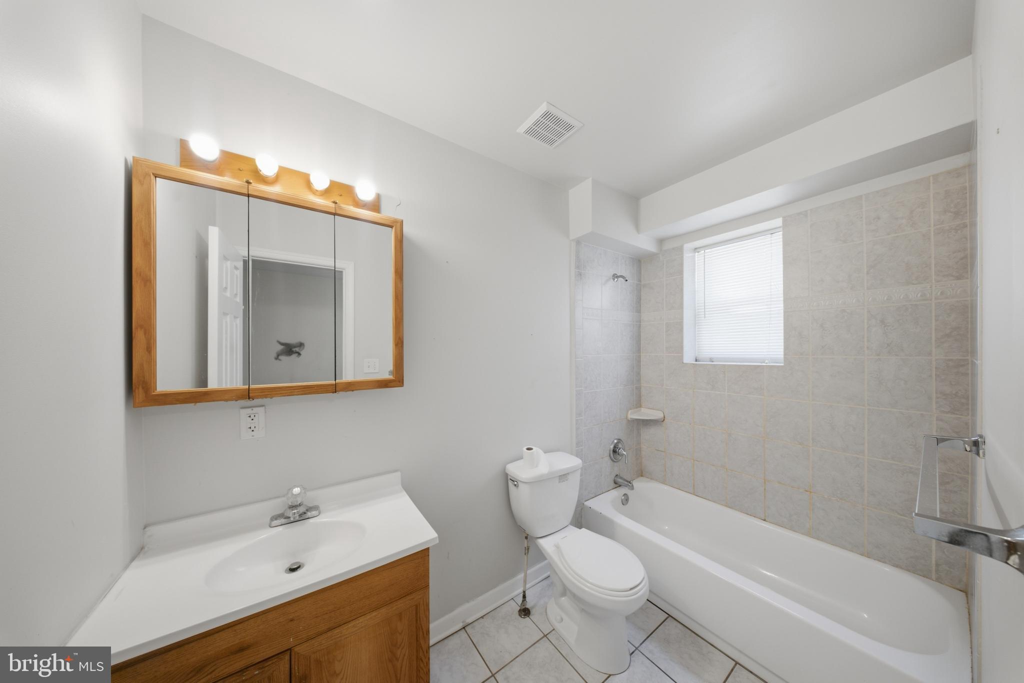 7611 Temple Hill Road Temple Hills, MD 20748 - Photo 8 of 25 a bathroom with a sink mirror vanity and toilet