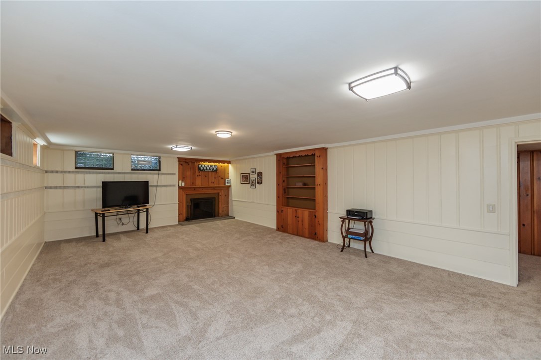 4944 Middledale Road Lyndhurst, OH 44124 - Photo 33 of 44 Rec Room featuring carpet flooring, Glass block windows and a fireplace