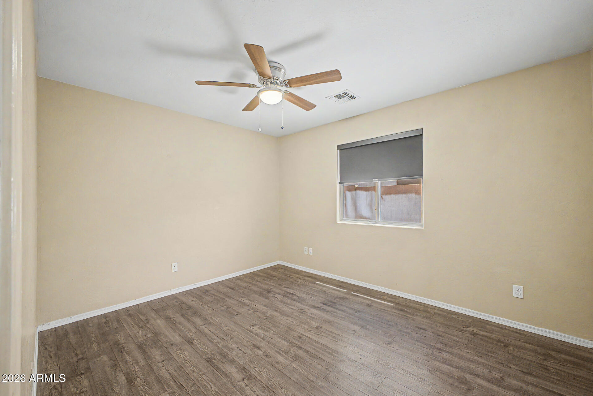 2340 West Apollo Road Phoenix, AZ 85041 - Photo 16 of 26 a view of a big room with wooden floor closet and windows in it
