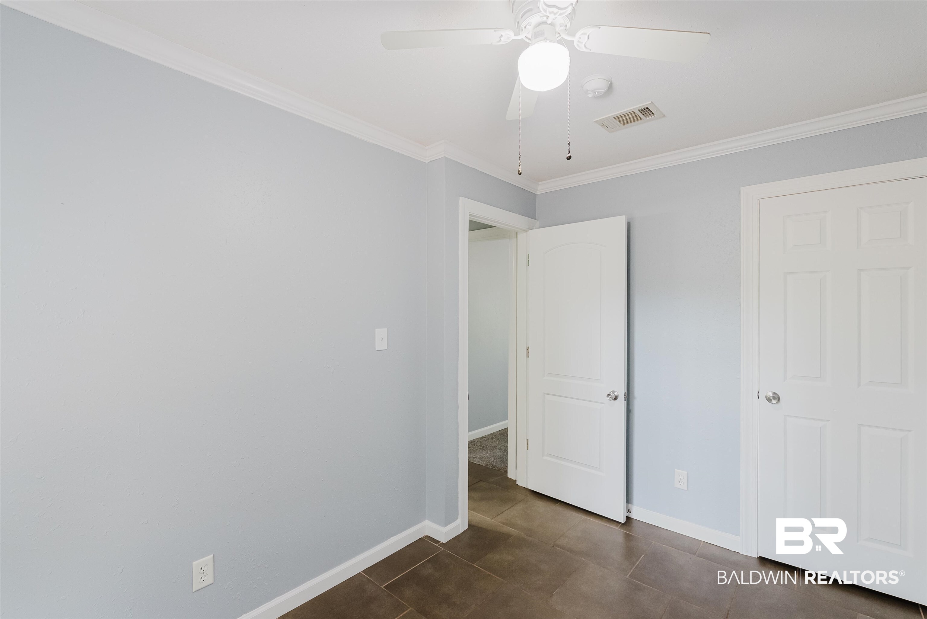 14185 Jackson Lane Foley, AL 36535 - Photo 12 of 16 Unfurnished bedroom featuring crown molding, a ceiling fan, and dark tile patterned flooring