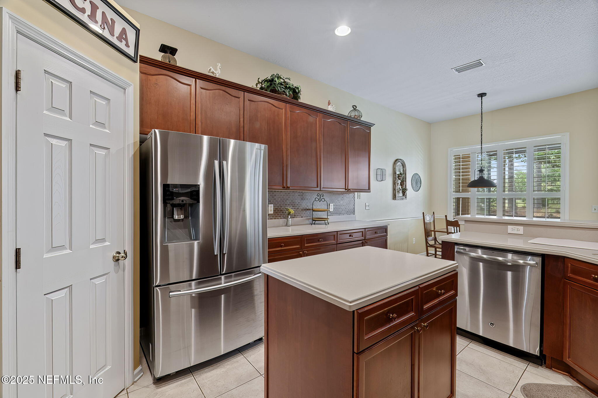 232 Porta Rosa Circle St. Augustine, FL 32092 - Photo 11 of 42 a kitchen with a refrigerator a sink and cabinets