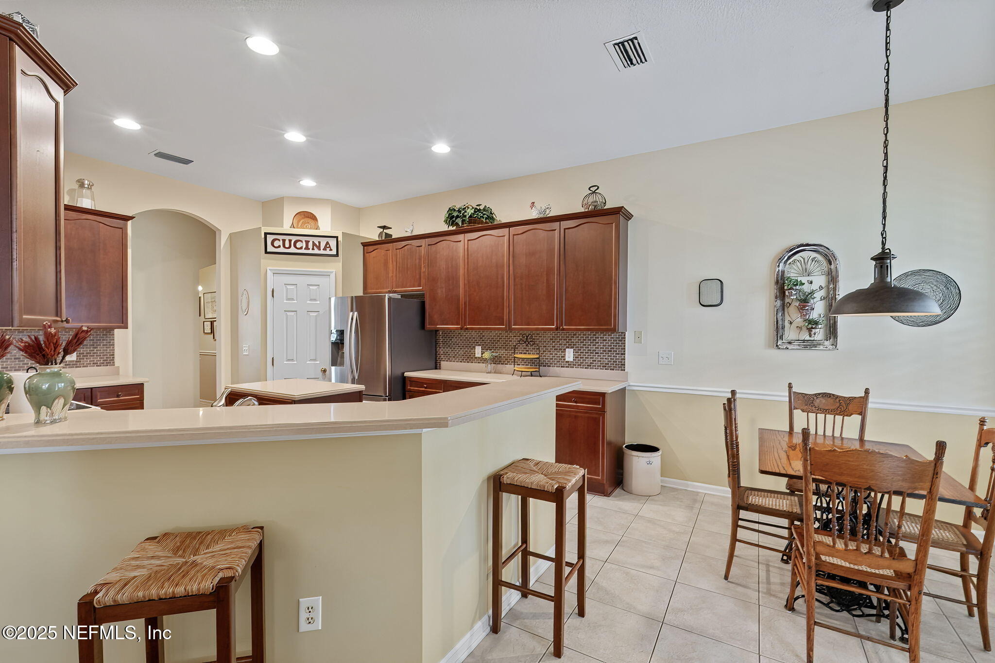 232 Porta Rosa Circle St. Augustine, FL 32092 - Photo 12 of 42 a kitchen with kitchen island granite countertop a table and chairs in it