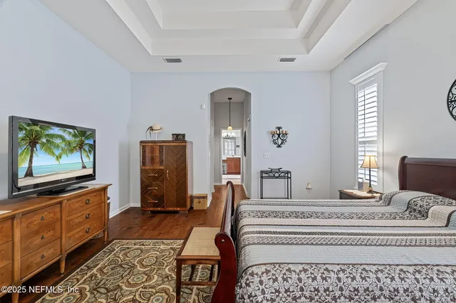 a bedroom with furniture and a flat screen tv