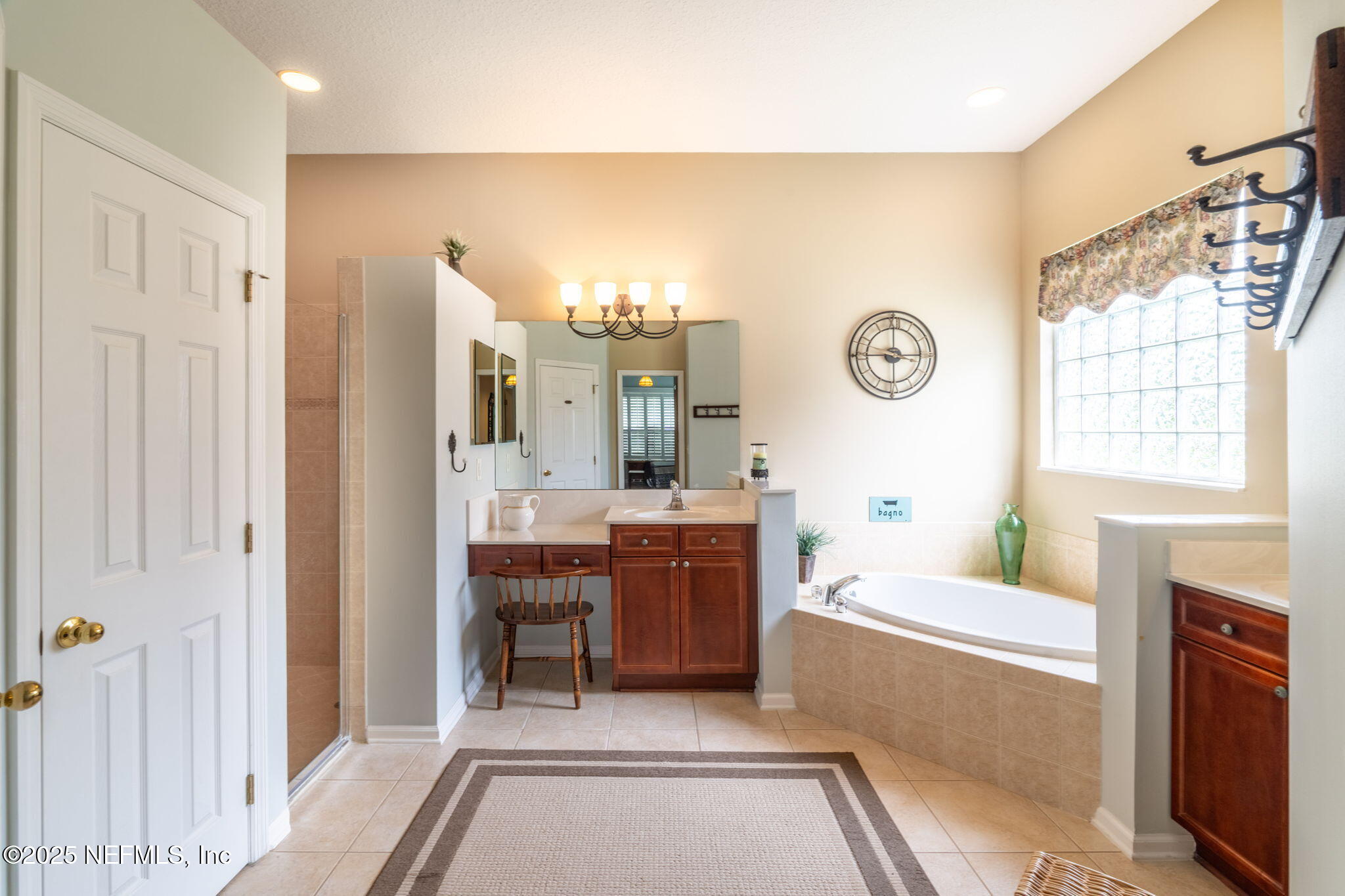 232 Porta Rosa Circle St. Augustine, FL 32092 - Photo 18 of 42 a bathroom with a tub a sink and a large mirror