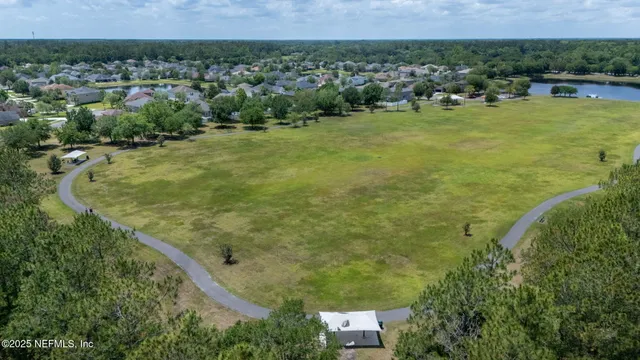 an aerial view of a house with a yard