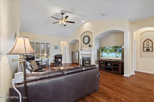 a living room with fireplace furniture and a flat screen tv