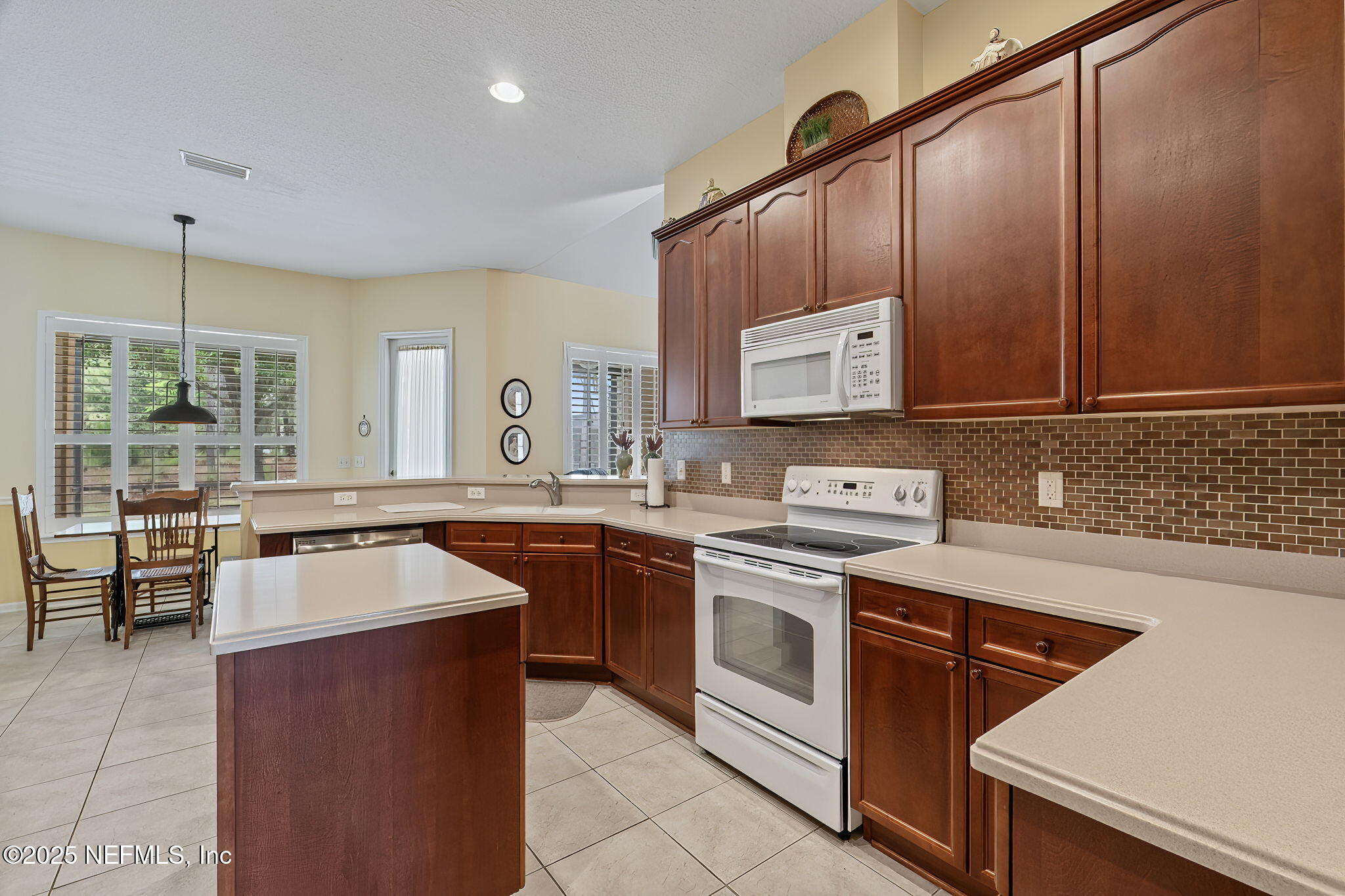232 Porta Rosa Circle St. Augustine, FL 32092 - Photo 10 of 42 a kitchen with stainless steel appliances granite countertop a sink stove and refrigerator