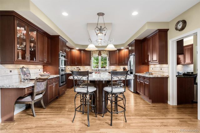 a kitchen with a sink stove and refrigerator