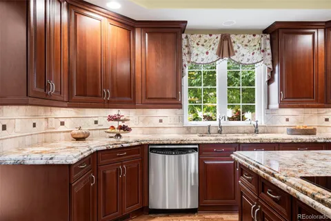 a spacious bathroom with a double vanity sink toilet mirror and bathtub