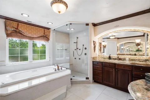 a spacious bedroom with a bed and a chandelier