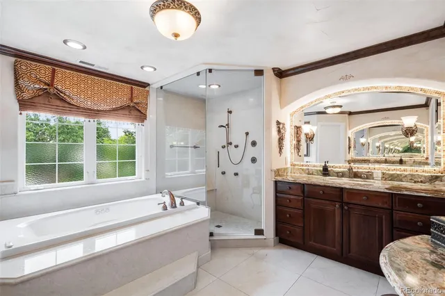 a spacious bedroom with a bed and a chandelier