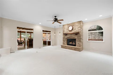 a view of an empty room with a fireplace and a window